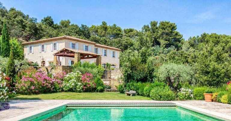 Typical Provençal bastide with stone facade and shutters in Provence